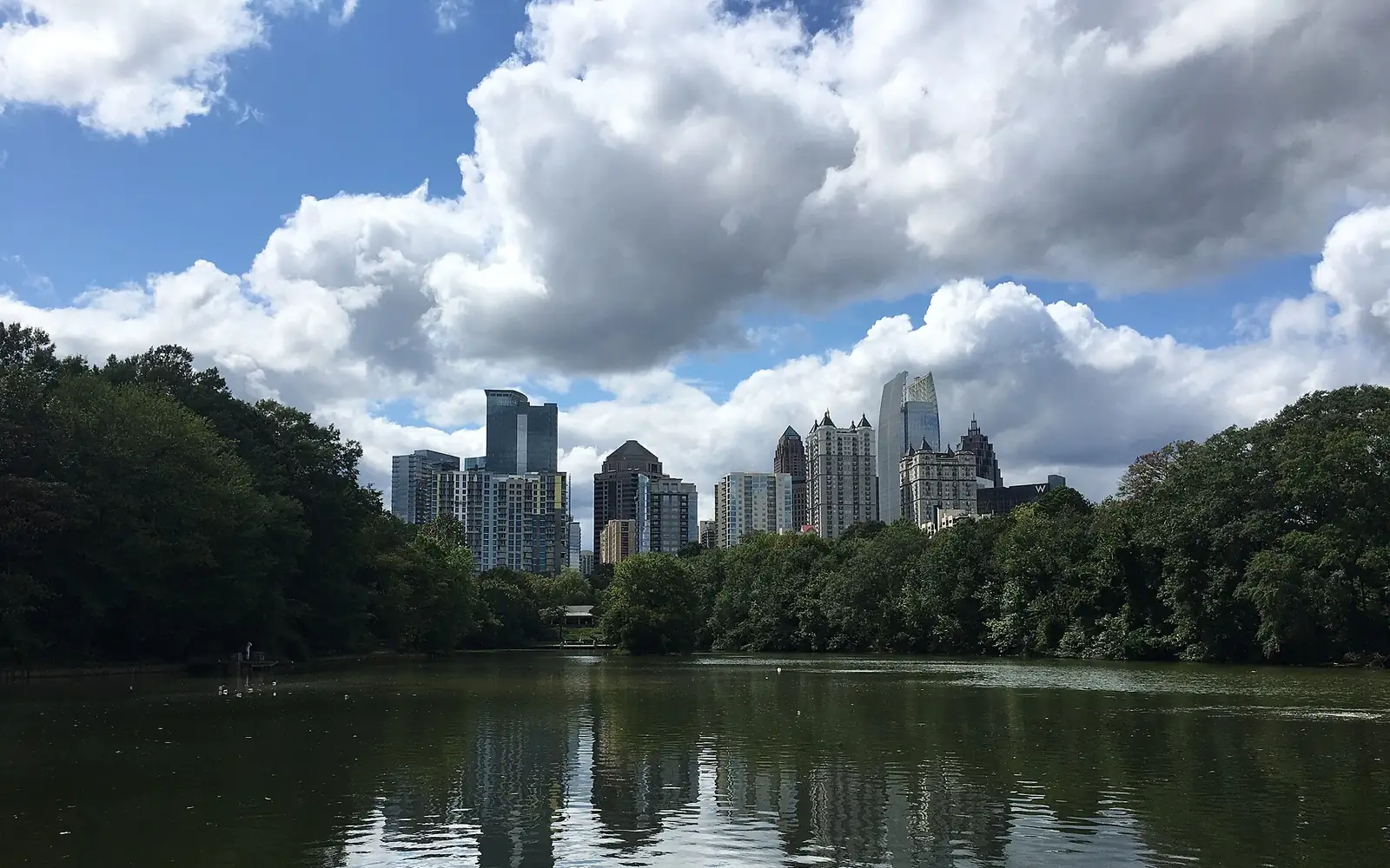 Piedmont Park lake below the Atlanta skyline