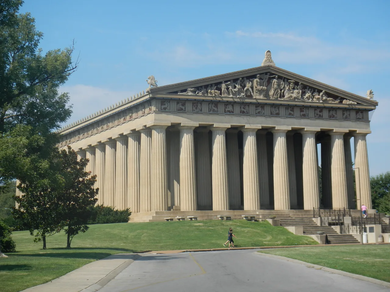 The full-scale Parthenon replica on the green lawn of Centennial Park, Nashville, under a clear blue summer sky
